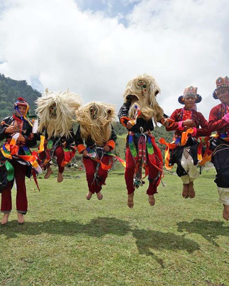 Yak-hair masked dancers leaping at the Sakteng village festival in eastern Bhutan